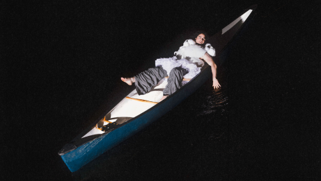Jeremy Dutcher lounging in a canoe