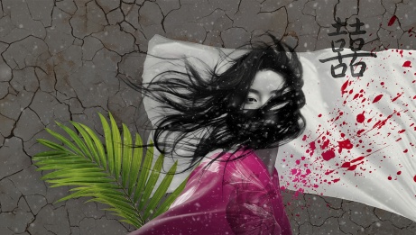 An Asian woman with hair in her face looks at the camera in front of a cracked concrete background. There is a white flag with red and magenta splatters and a green leaf behind her.  