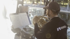 French Horn player Lawrence Vine plays his instrument at sunset on a boat on the Rideau Canal. 