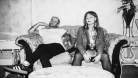 Miesha and the Spanks, in black and white, sitting on a couch 