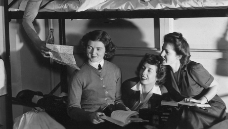 Three women read a letter from Canadian soldier