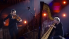 Catrin Finch with her harp and Aoife Ní Bhriain with her violin. Both are performing on stage together. © Jennie Caldwell