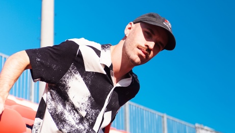 David Emme with a blue sky behind him. He is wearing a hat.