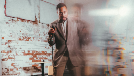 A blurry picture of Cadence Fitzpatrick in a brown suit.